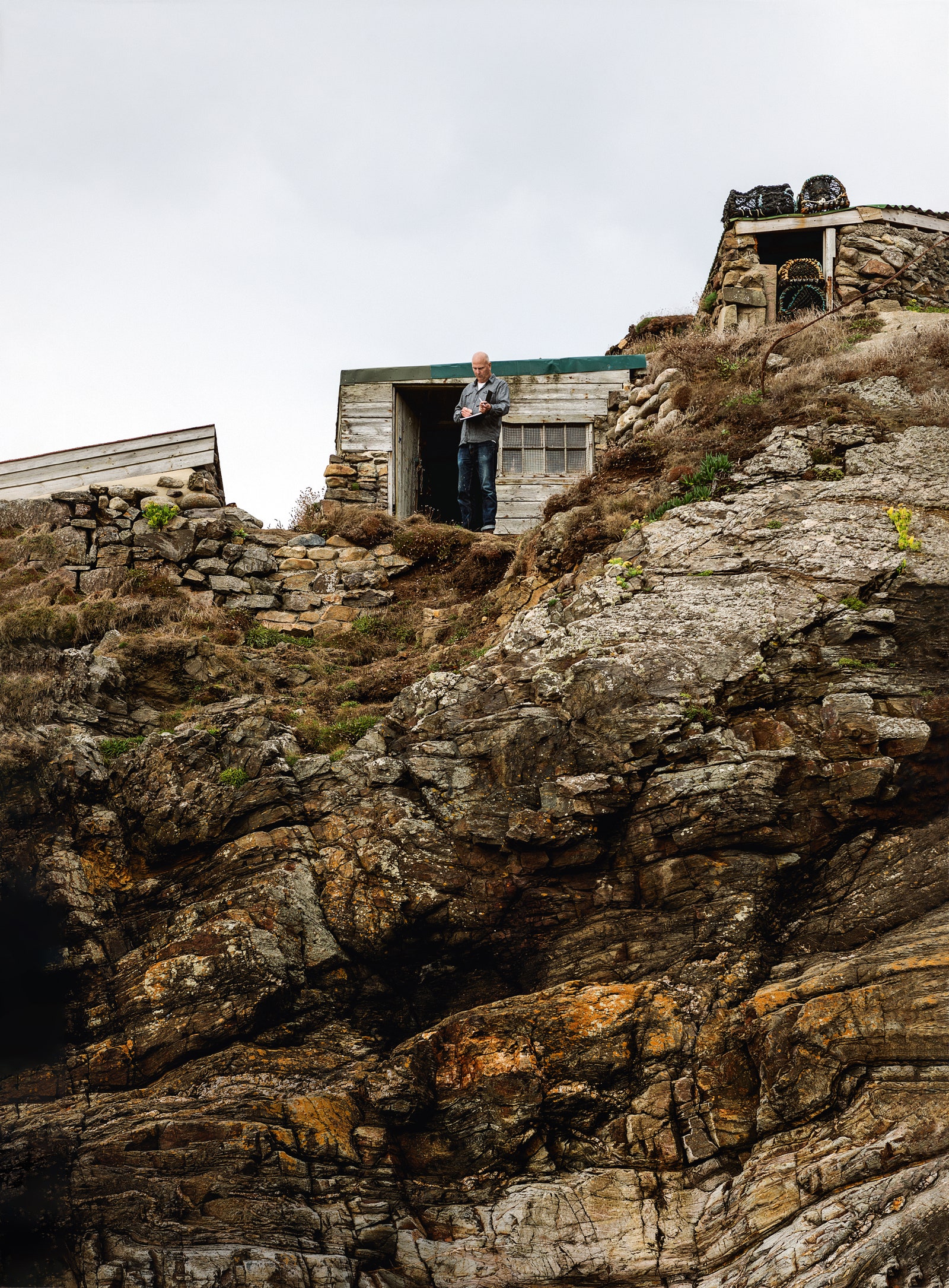 Artist Kurt Jackson outside the clifftop hut that he uses as a studio near St Just in Cornwall